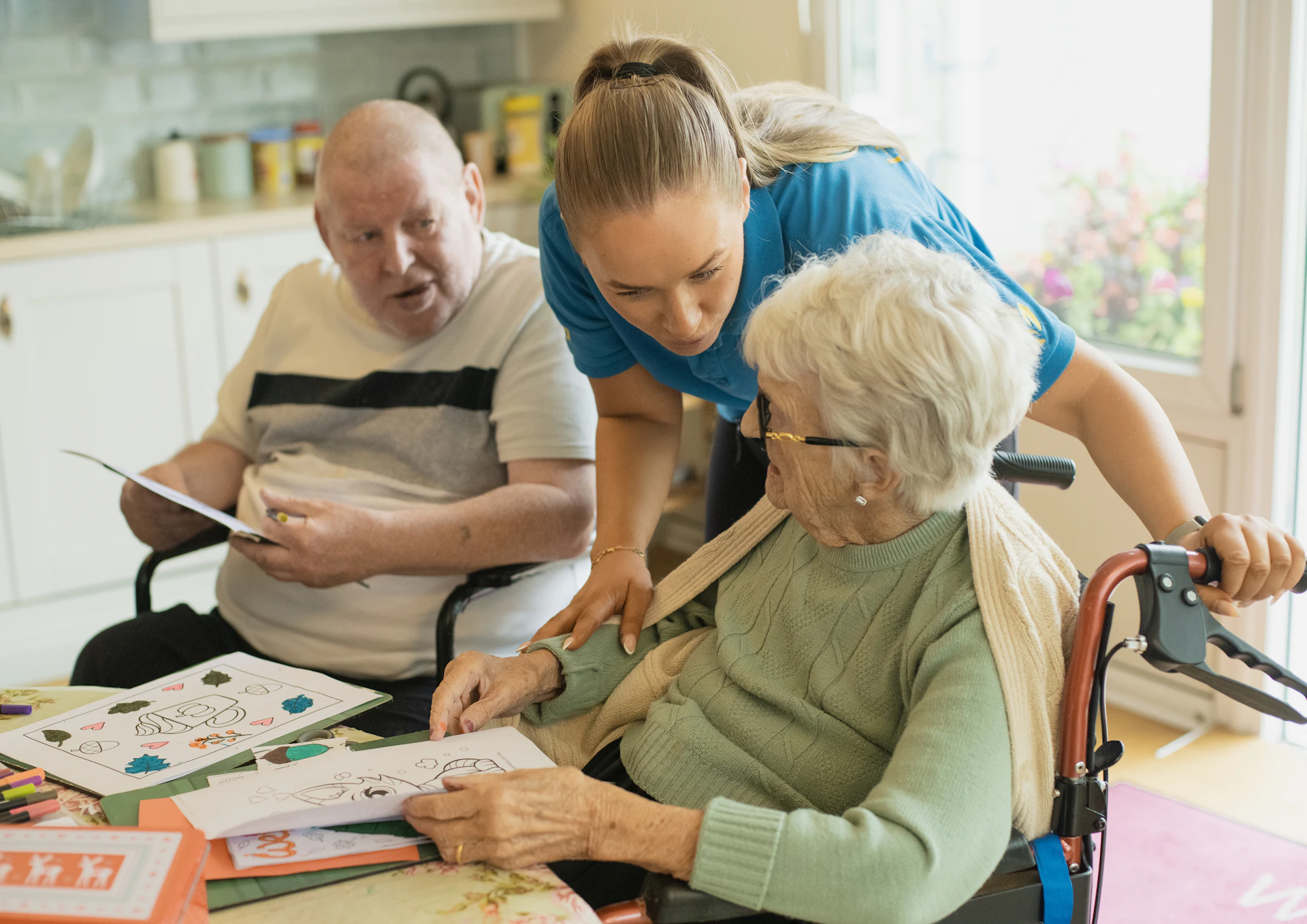 Carer supporting an elderly couple at home