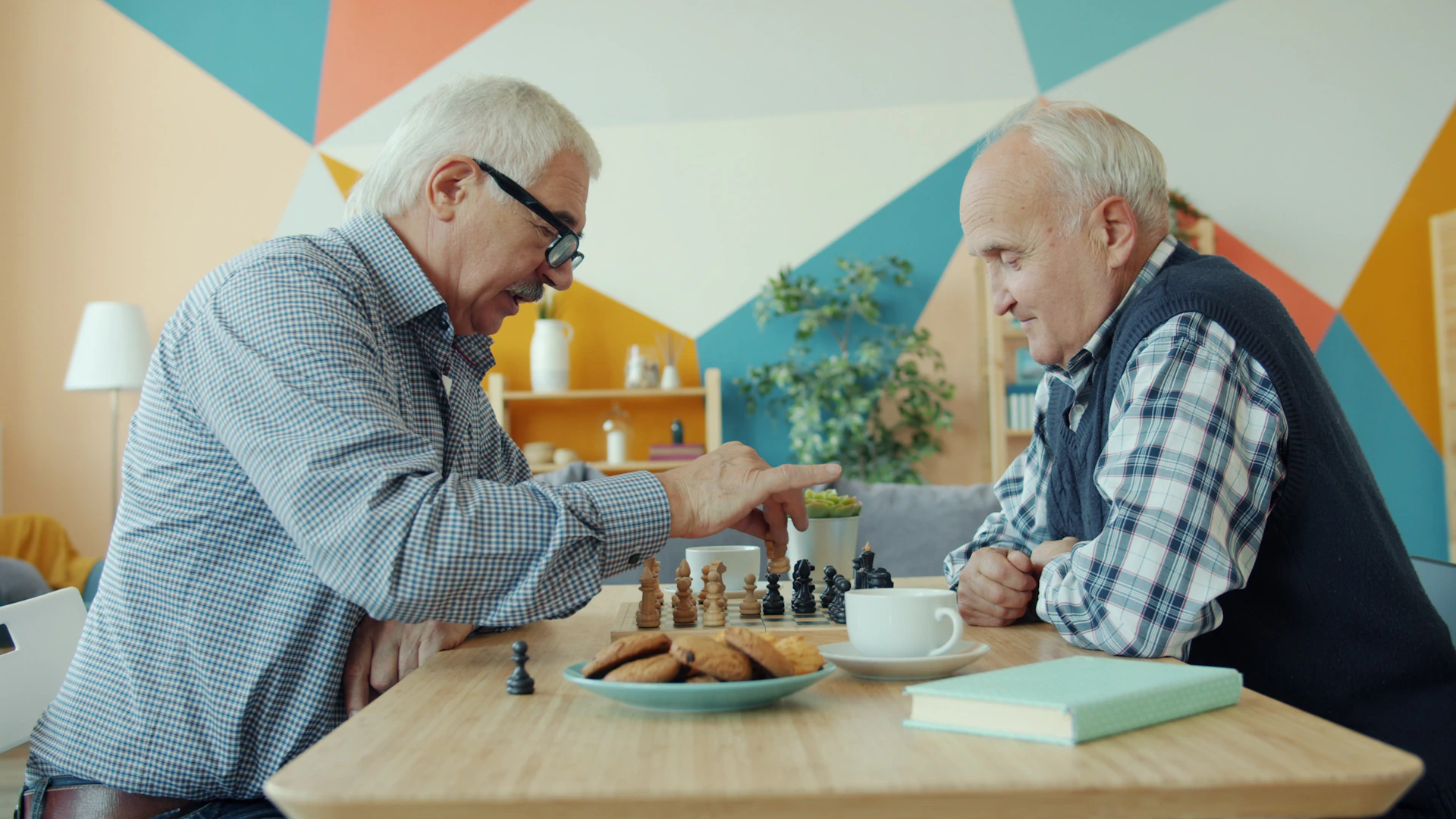 Two older men playing chess together