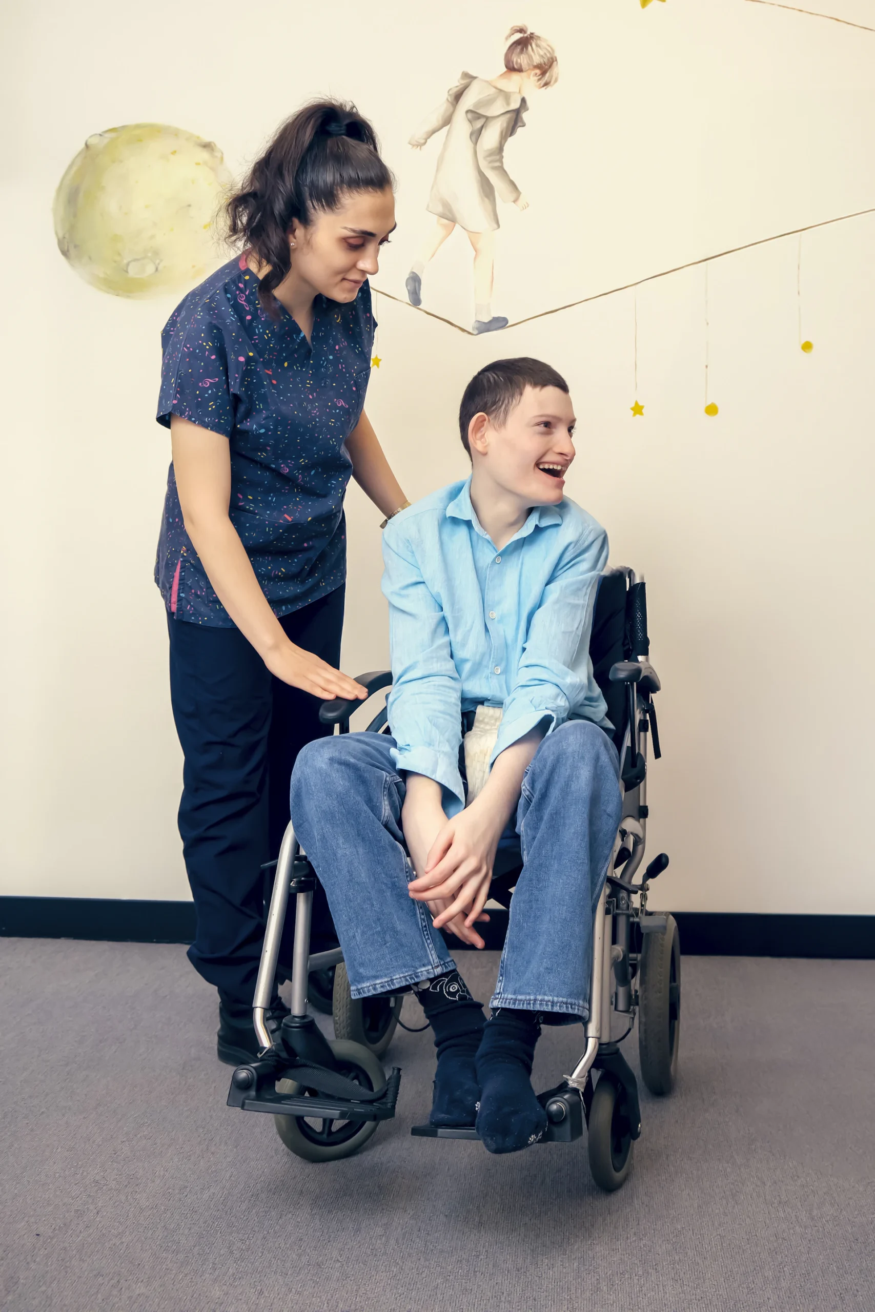 Young person in a wheelchair with a support worker